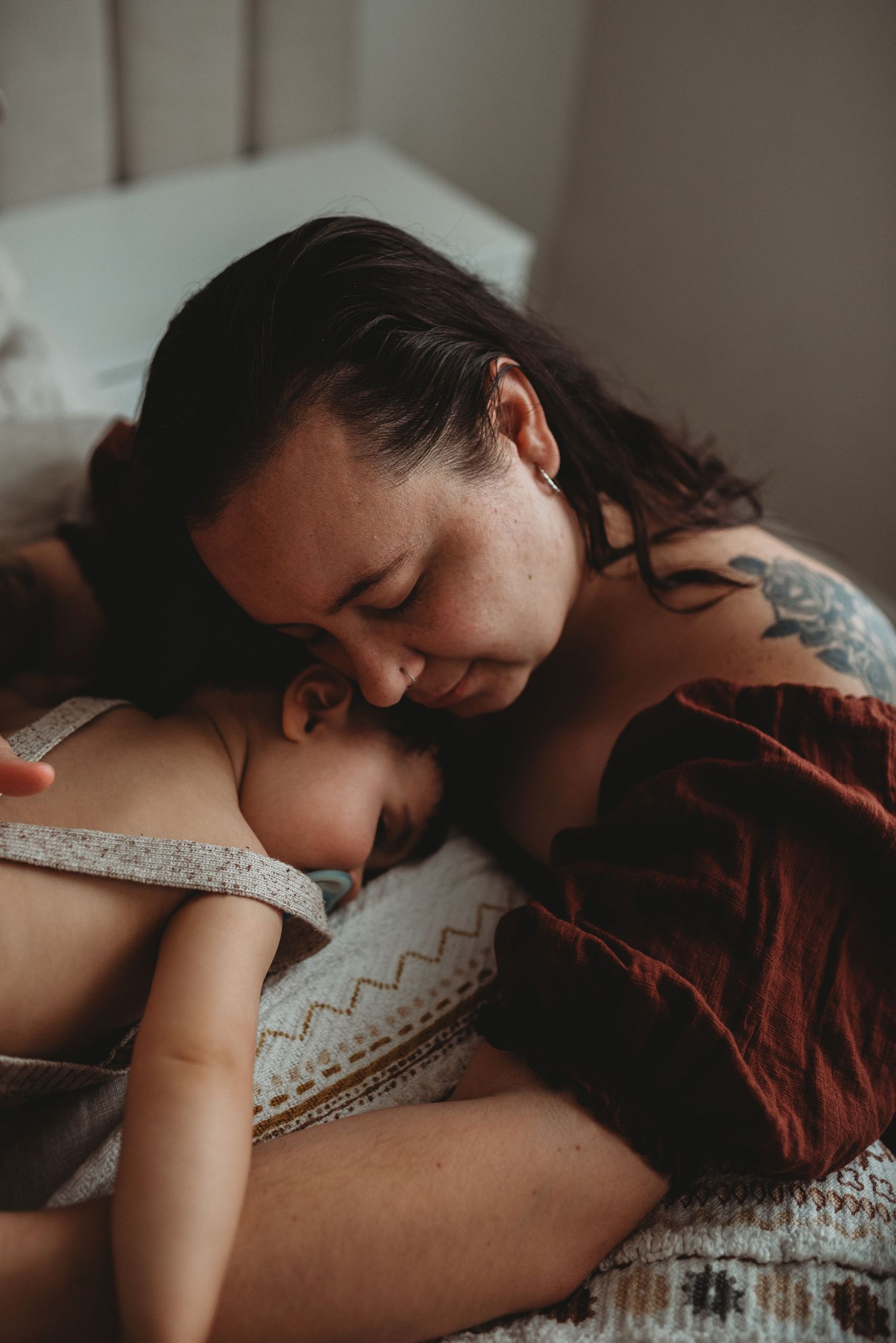 Peaceful nursing session captured in intimate documentary style photography.