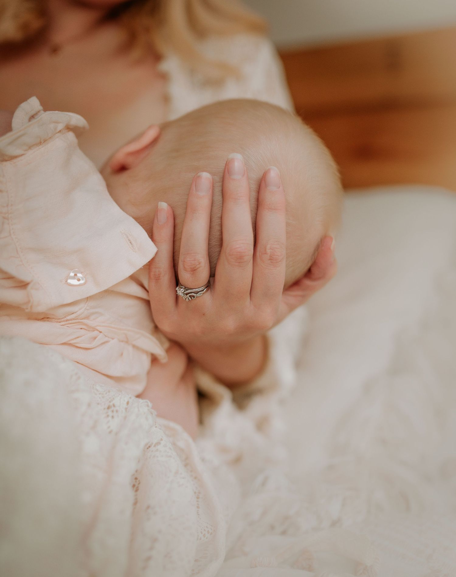 Close-up details of delicate lace fabric and hands in soft natural lighting.