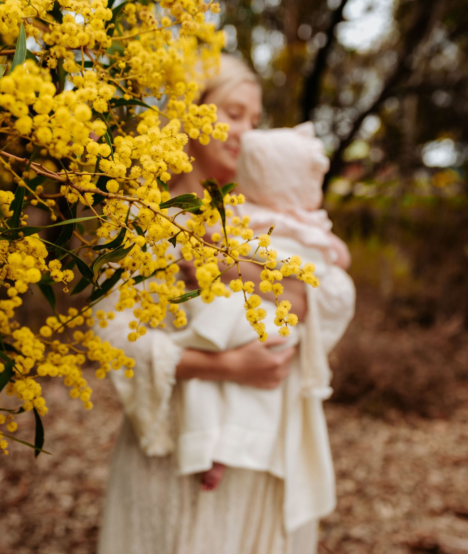 White dress against vibrant yellow spring flowers in outdoor setting.