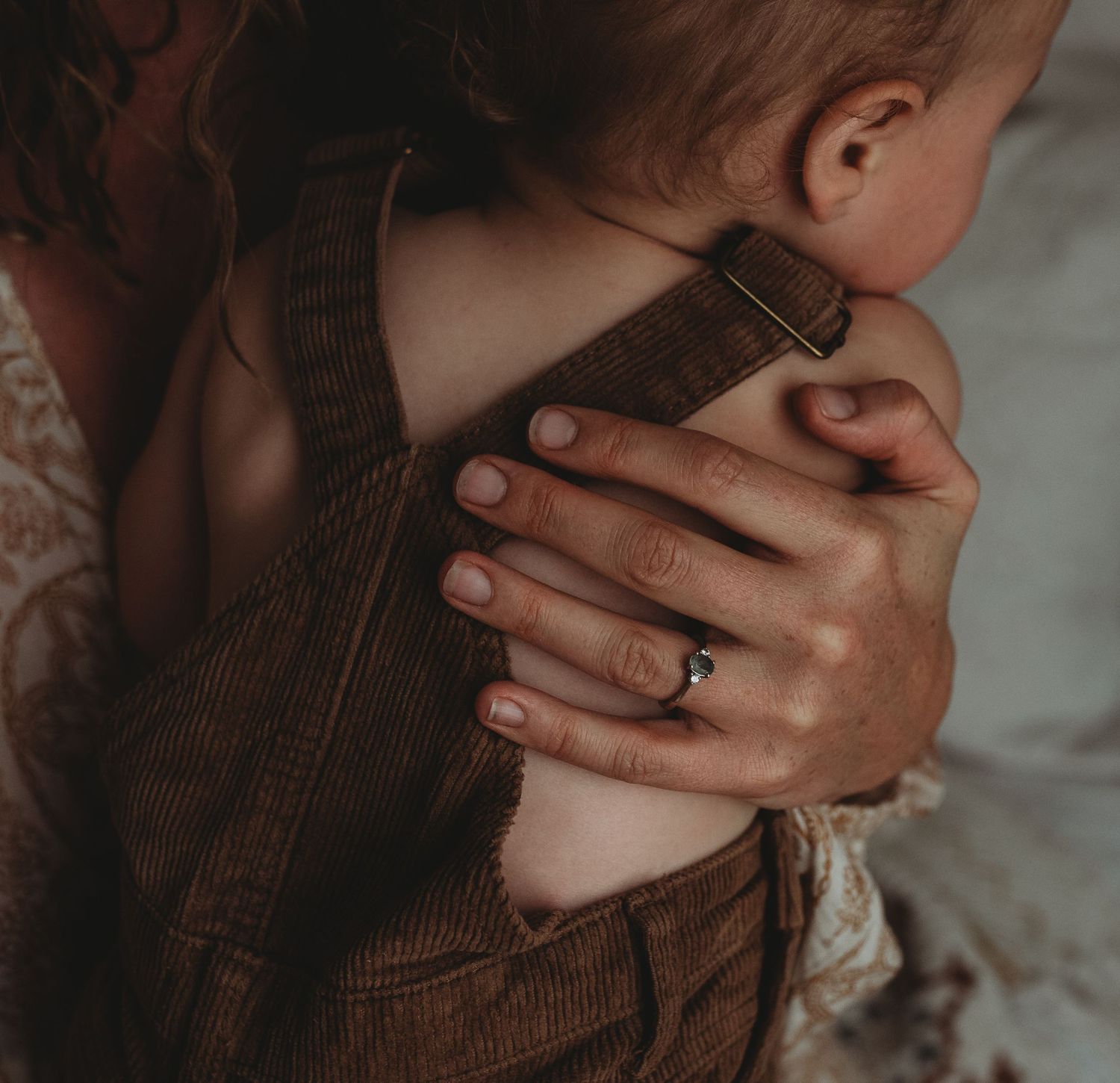 Lifestyle photo shows hands and corduroy fabric in moody natural lighting.