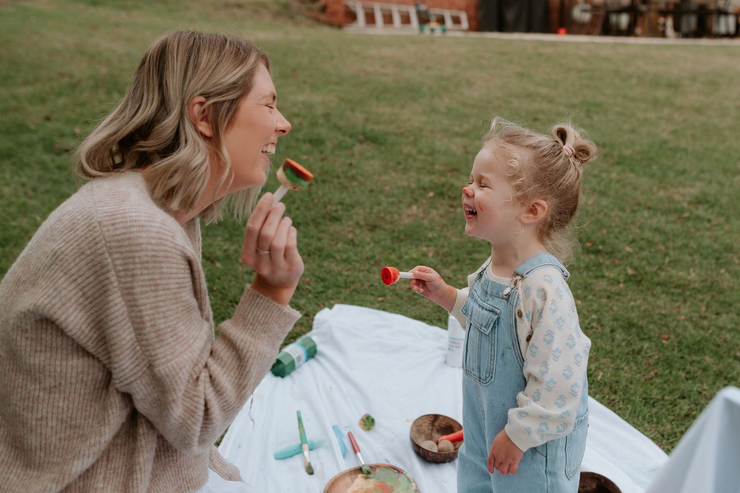 Outdoor playtime scene with toys and natural lighting on a grassy lawn.