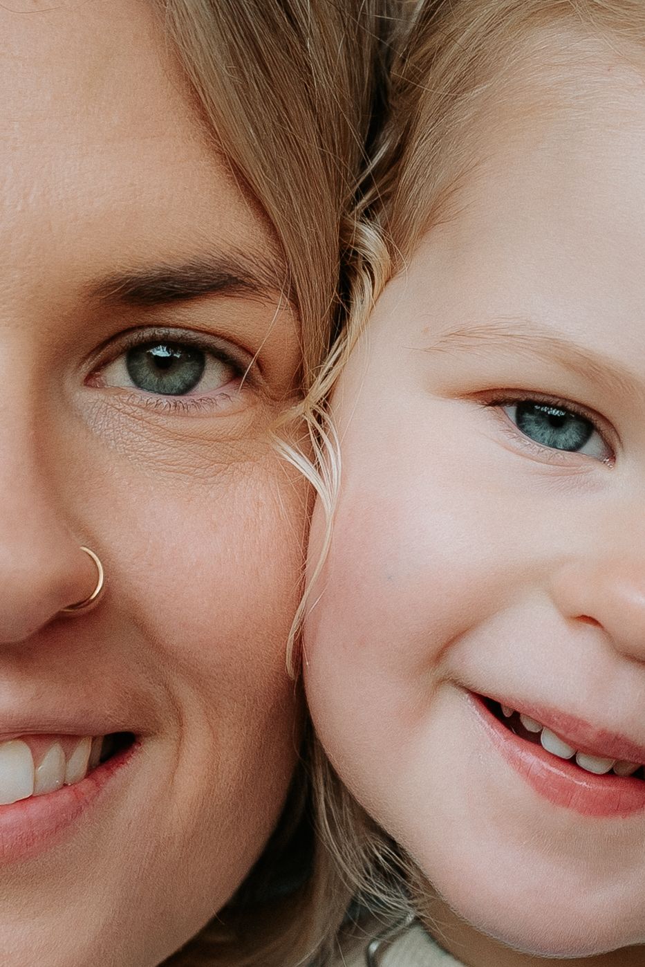 Close-up portrait showing bright blue eyes and joyful smiles.