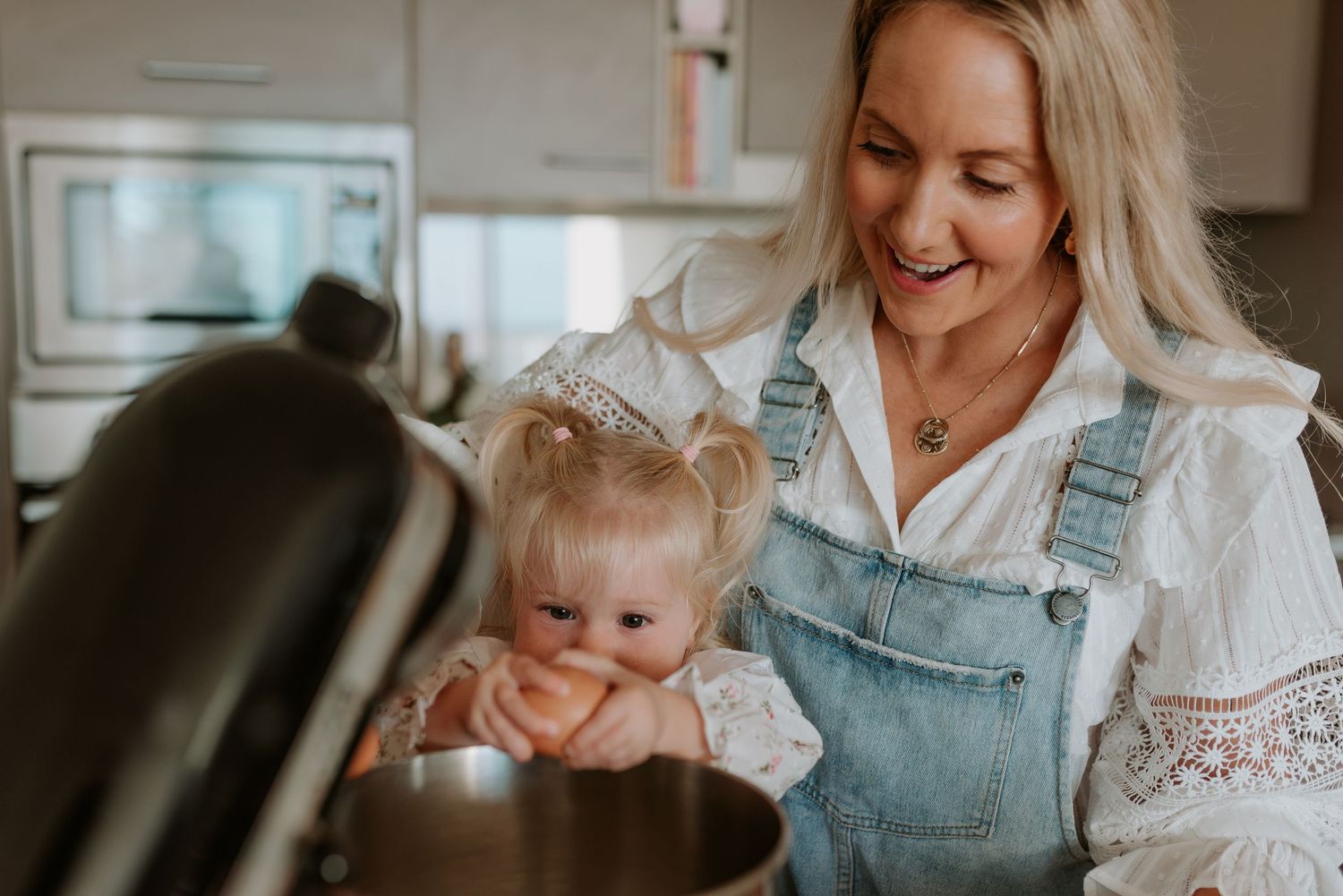 A joyful kitchen scene with a stand mixer and baking ingredients.