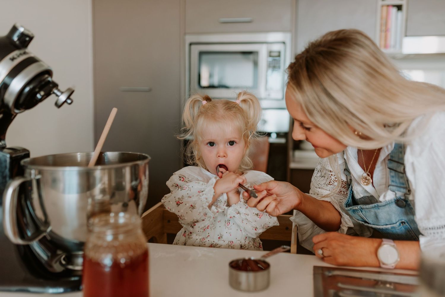 A cozy kitchen scene with baking activities and warm lighting.