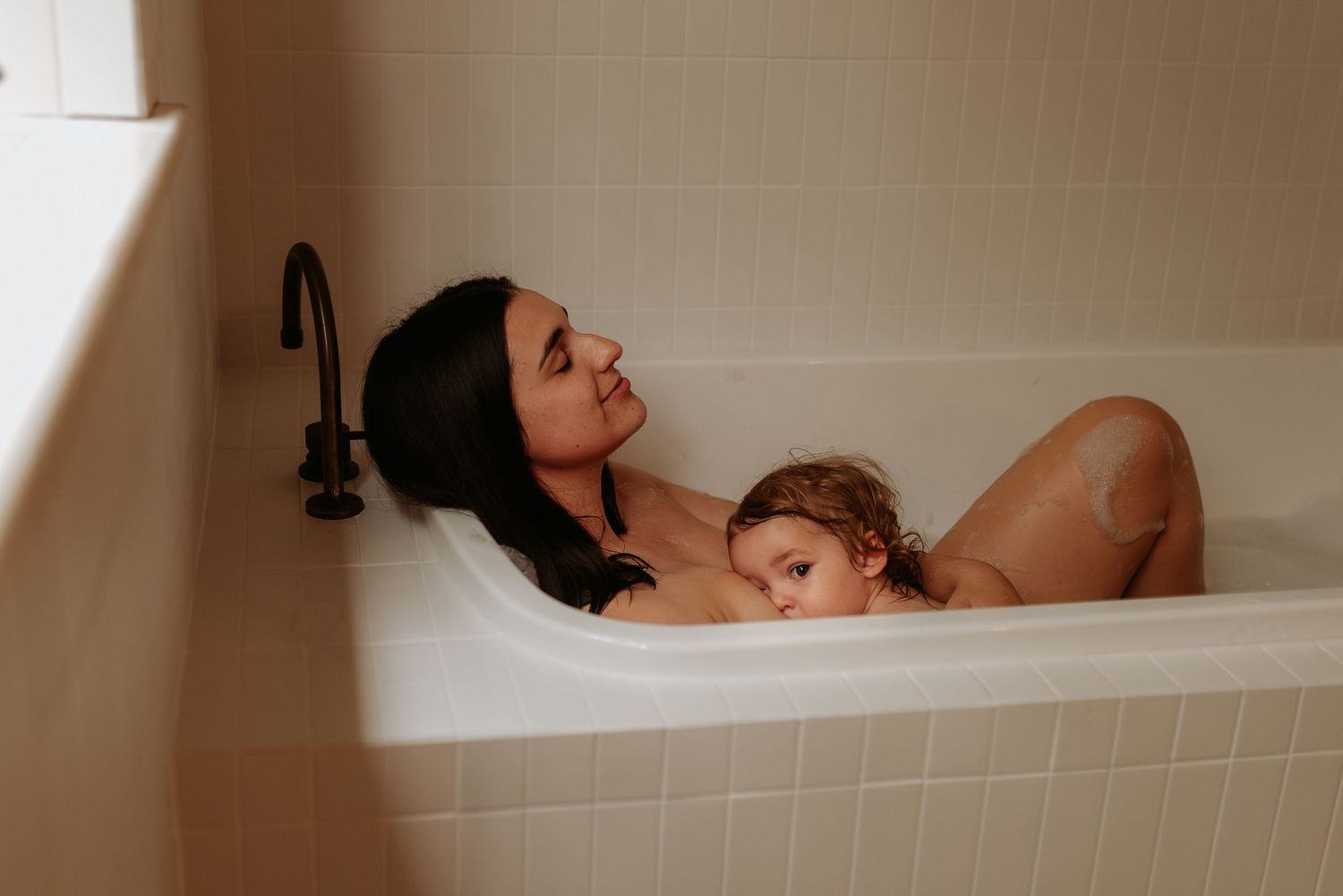 Artistic black and white photograph of bath time bonding moment.