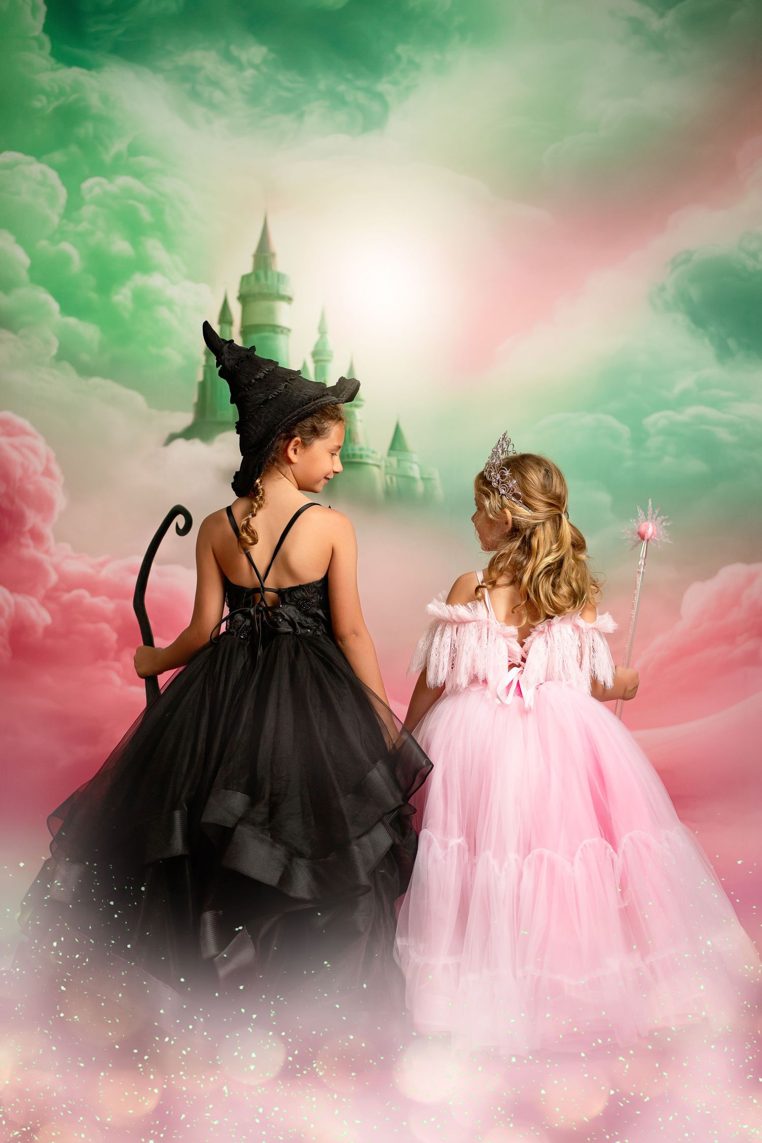 Fantasy portrait of a young princess in a pink tulle gown against dreamy clouds and distant fairytale castle.