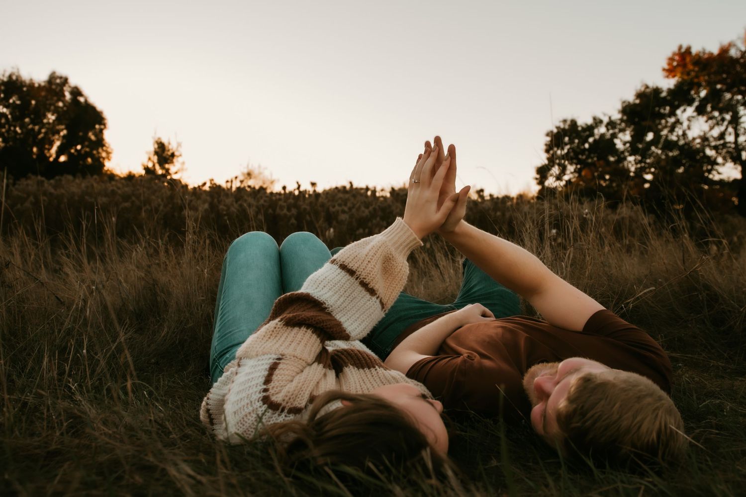 A collection of artistic silhouette photos showing intimate poses of couples at sunset in a natural outdoor setting.