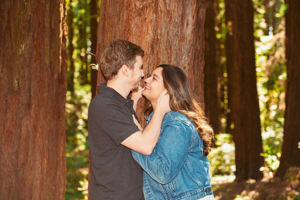 Sweet romantic moment shared during forest picnic date.