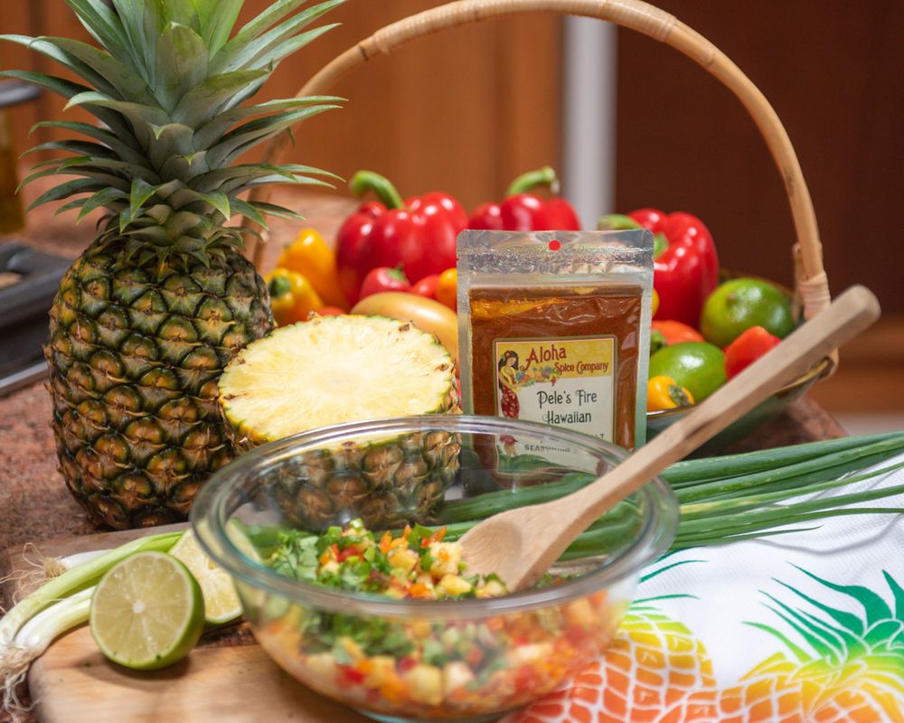 Kitchen scene with fresh pineapple, bell peppers and cooking ingredients.