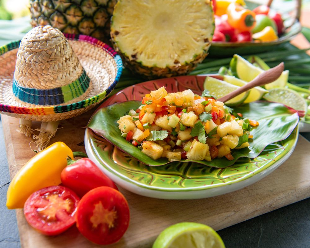 Hawaiian-style pineapple salad with colorful vegetables and decorative sombrero.