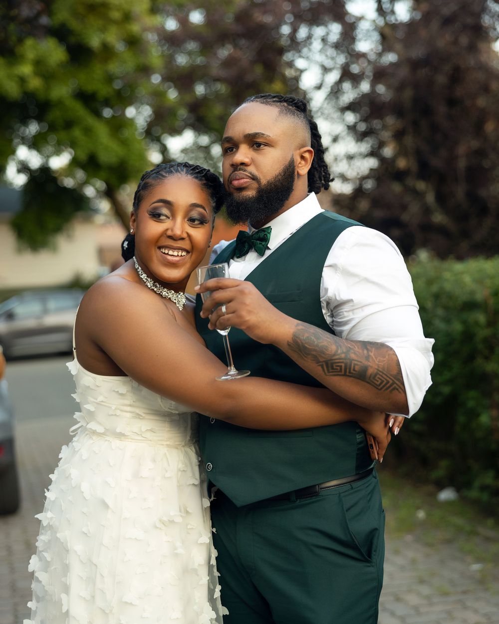 A romantic outdoor wedding portrait showing affection and joy.
