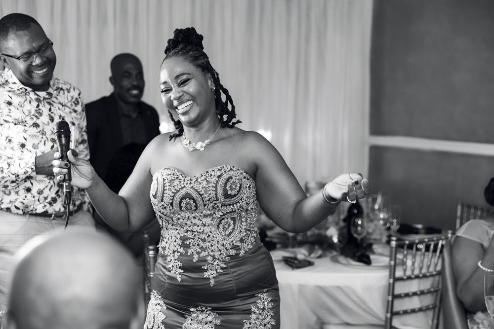 A candid black and white reception moment capturing pure joy and celebration.