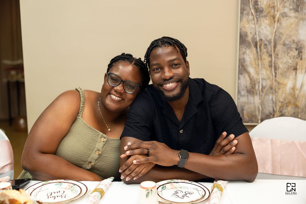 Intimate wedding reception moment captured at a table setting with decorative plates.