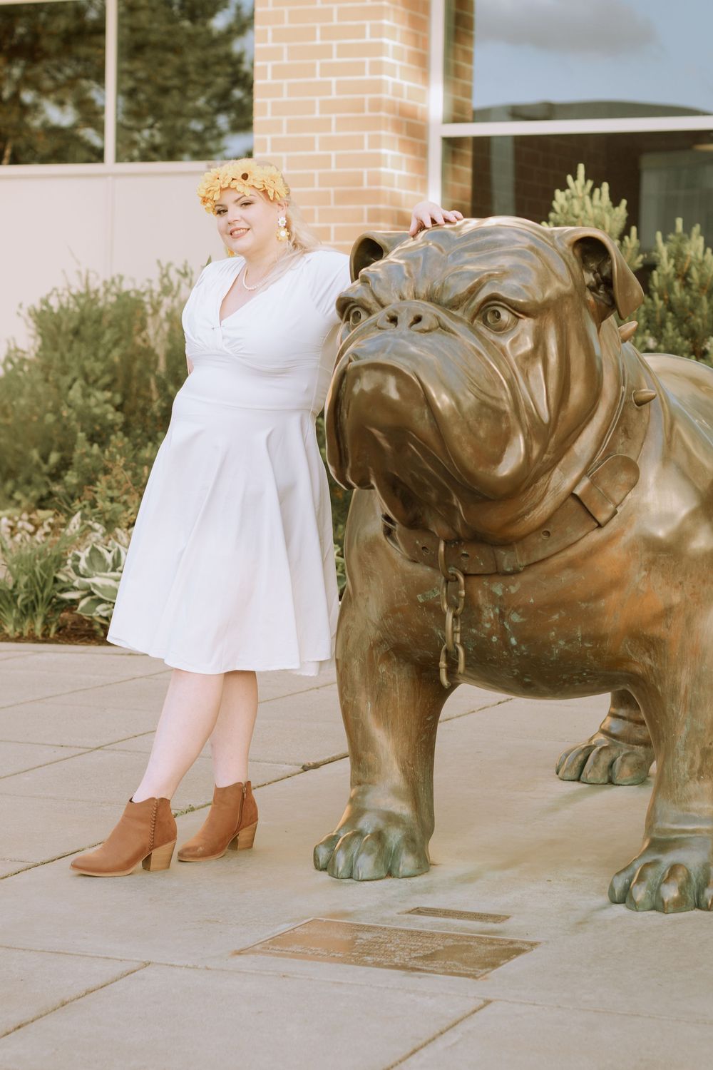 Gonzaga graduate posed with Spike the Bulldog on university campus.