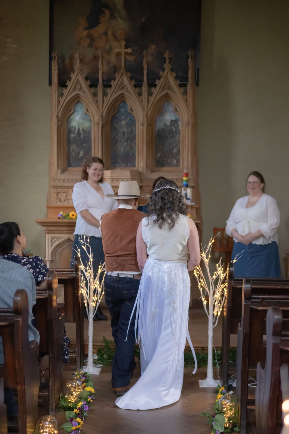Several frames show people in white wedding attire inside a church with ornate gothic windows and glowing floral decorations.