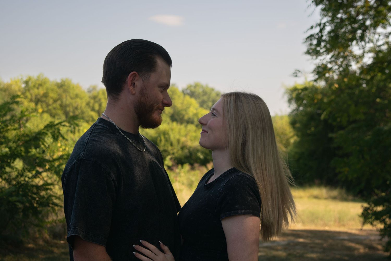 Couple standing in front of each other smiling