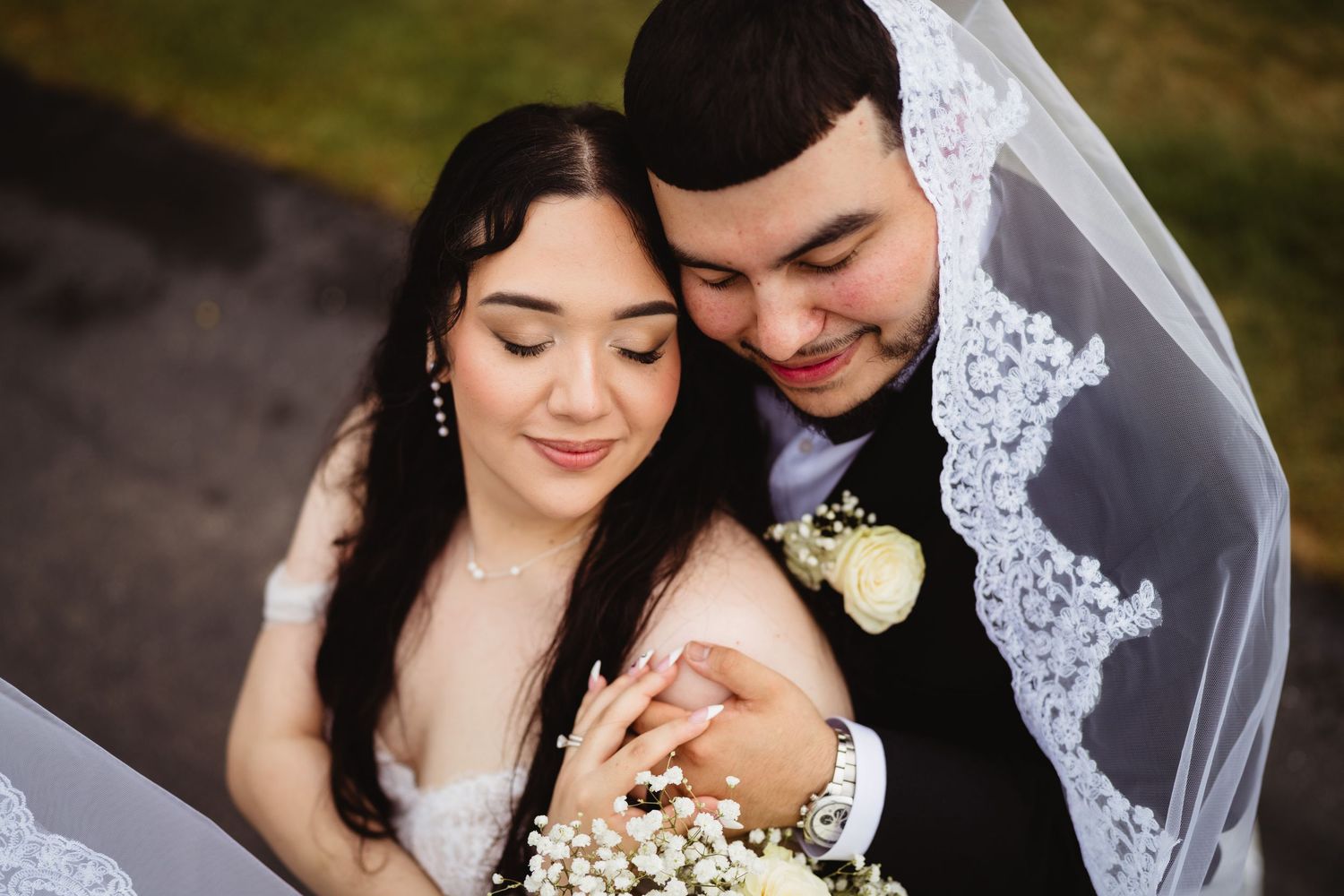A couple shares intimate wedding moments in a sequence of romantic photos featuring a white lace veil and floral details.