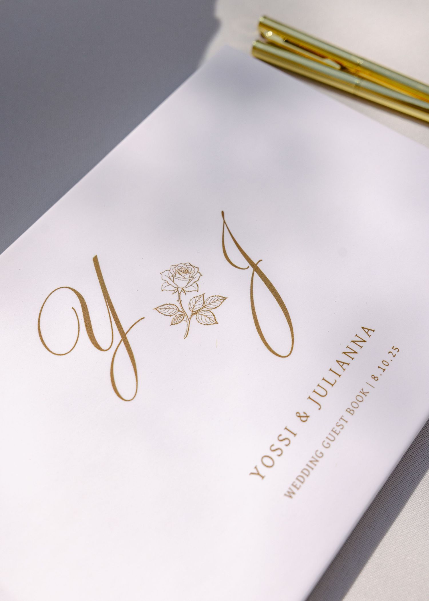 Elegant white and gold wedding invitation designs with calligraphy lettering against a light background.