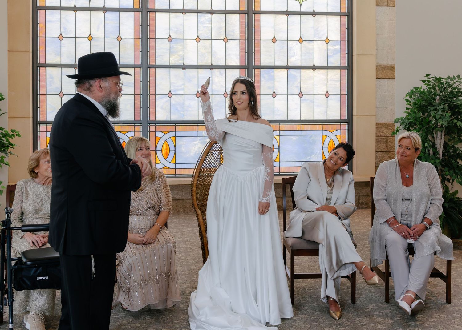 A series of wedding ceremony photos showing moments at an elegant indoor venue with decorative windows and classic decor.