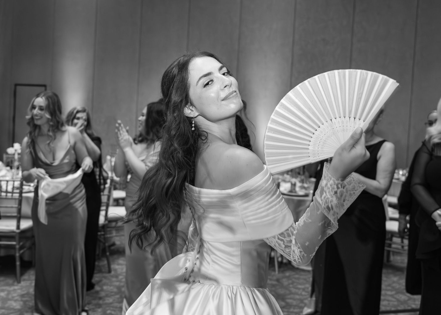 A collage of black and white photos showing dancers performing at an event with dramatic hand gestures and movements.