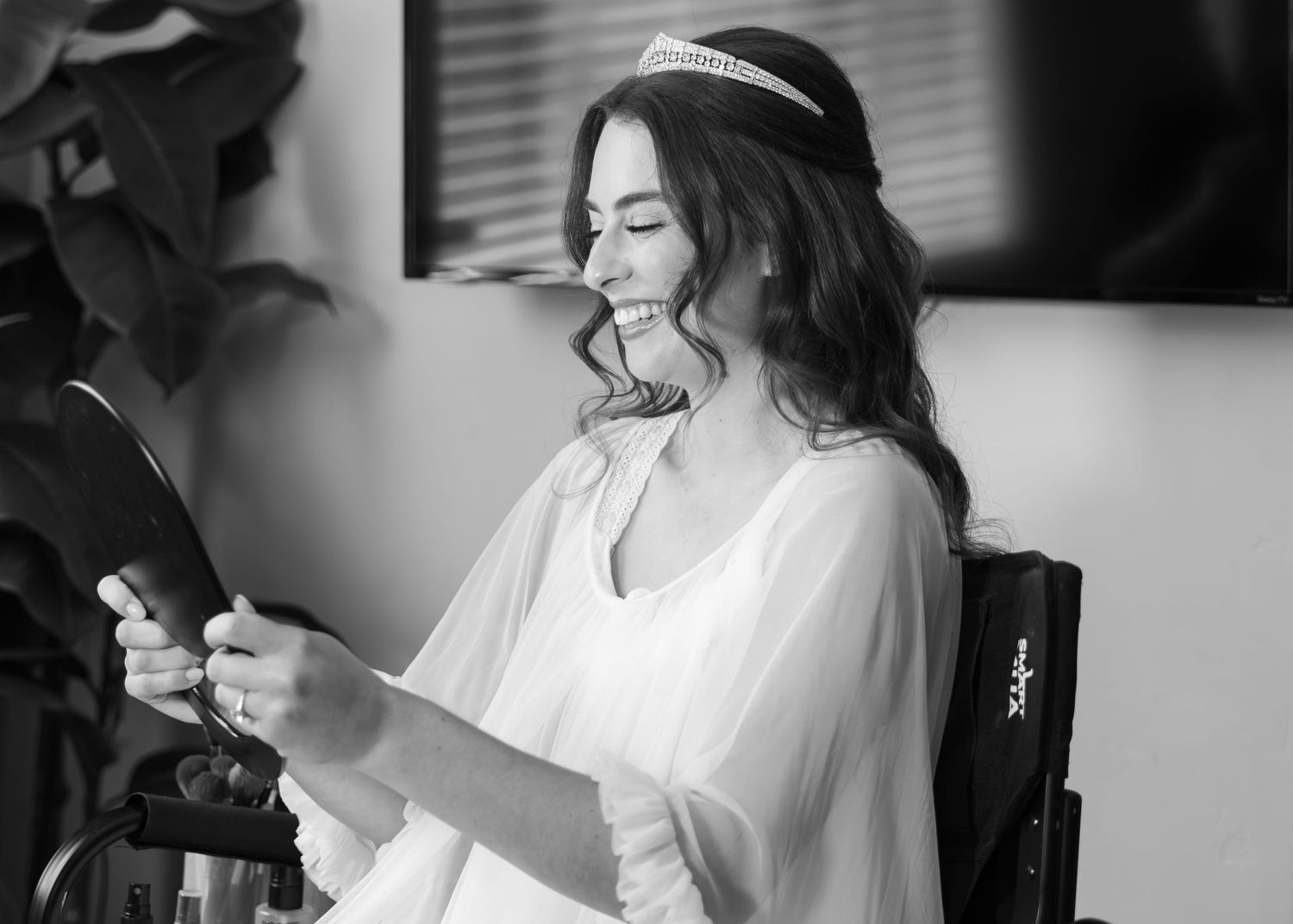 A series of black and white photos showing joyful moments during wedding preparations.