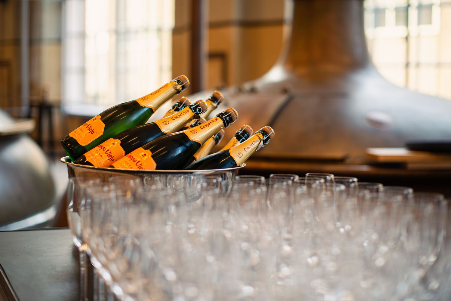 Line of champagne glasses awaiting service at an upscale event.