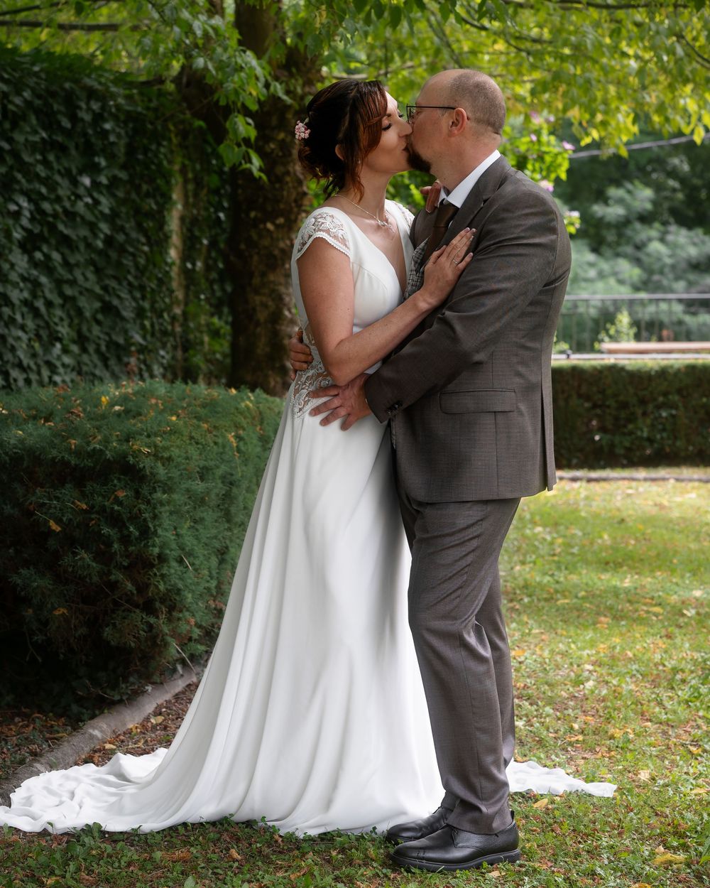A series of romantic outdoor wedding photos taken in a lush garden setting with natural greenery.