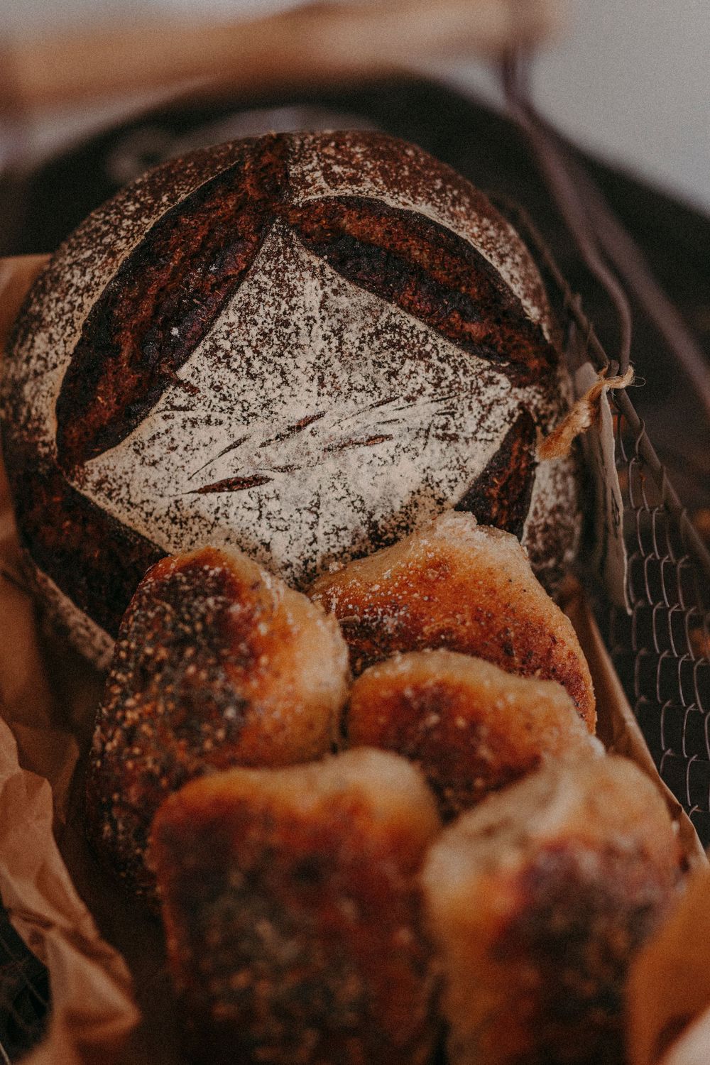 Close-up sequence of pulling apart a fresh-baked chocolate poppy seed bread showing soft, steamy interior texture.