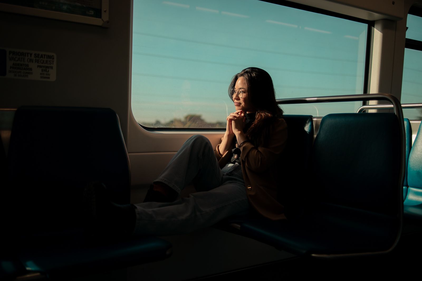 Cinematic Miami portrait on train, natural window light for editorial actors and musicians styled by MannyPortraits.