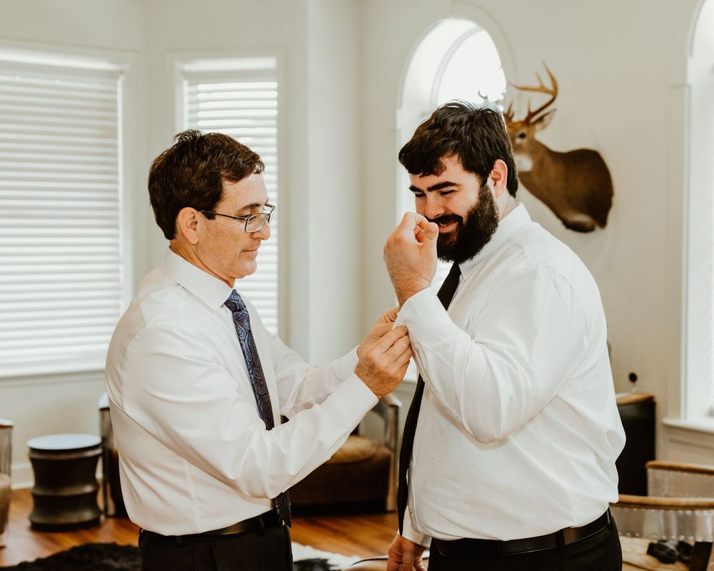 Business people in white shirts interacting and collaborating at a meeting table in an office setting.