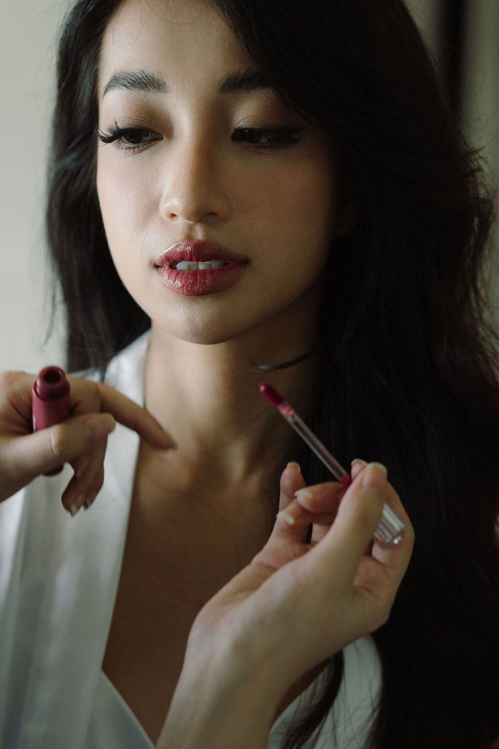 Applying lipstick in a close-up series of beauty preparation shots.