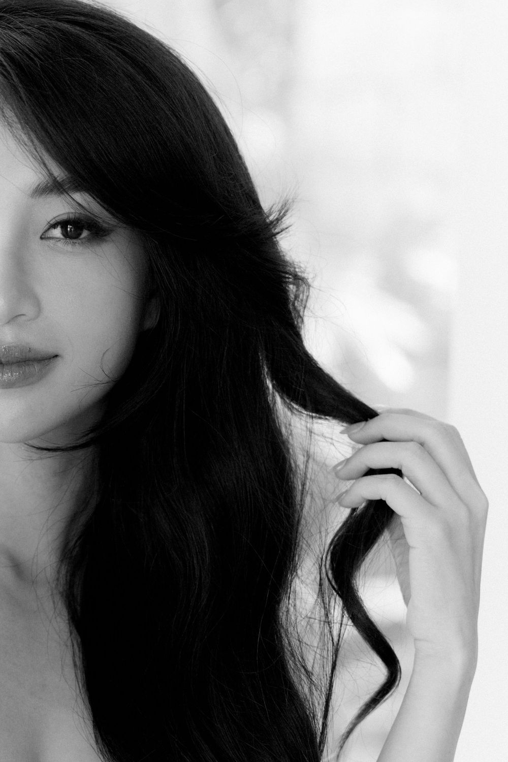 A black and white portrait series captures a flowing dark hair silhouette against a soft white background.