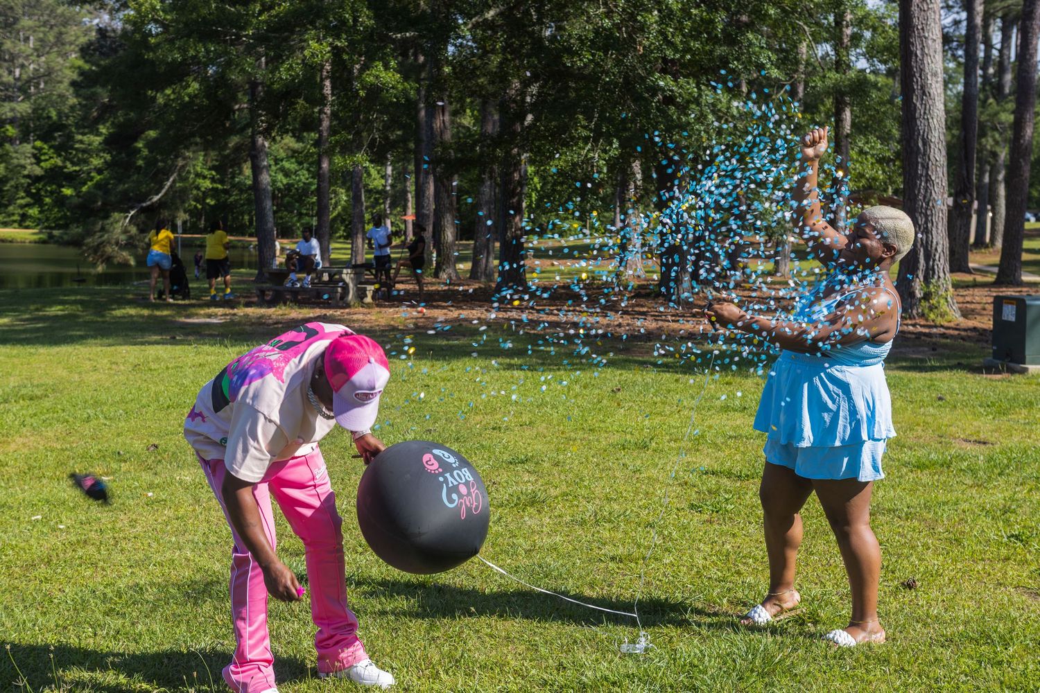 Children playing outdoor games with balls and activities on a sunny green lawn.