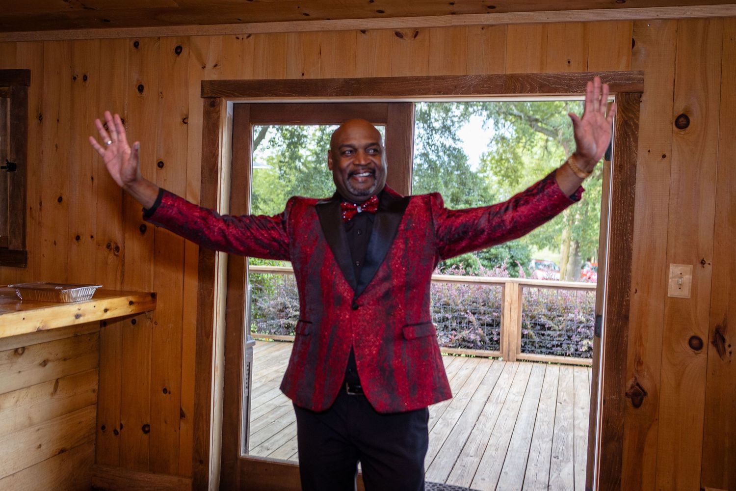 Celebratory poses inside a rustic wooden cabin with natural lighting.