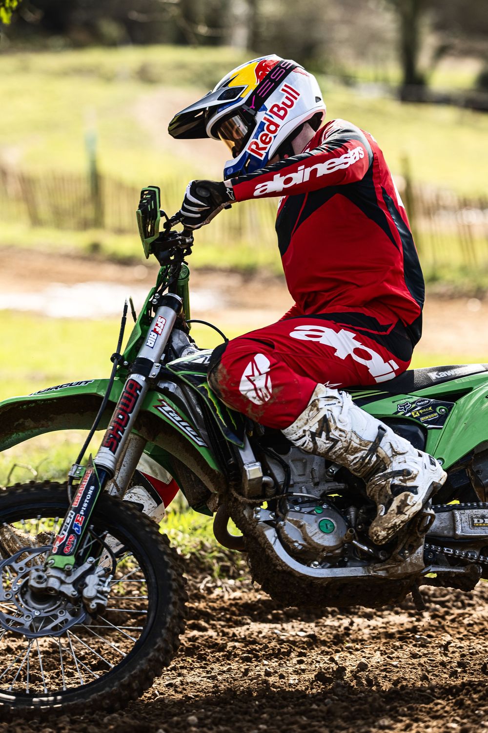 Action shots of a motocross rider racing through dirt track on a green Kawasaki motorcycle.