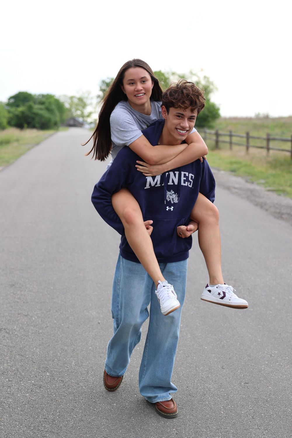 A sequence of playful piggyback images shows two people having fun on a paved path outdoors.