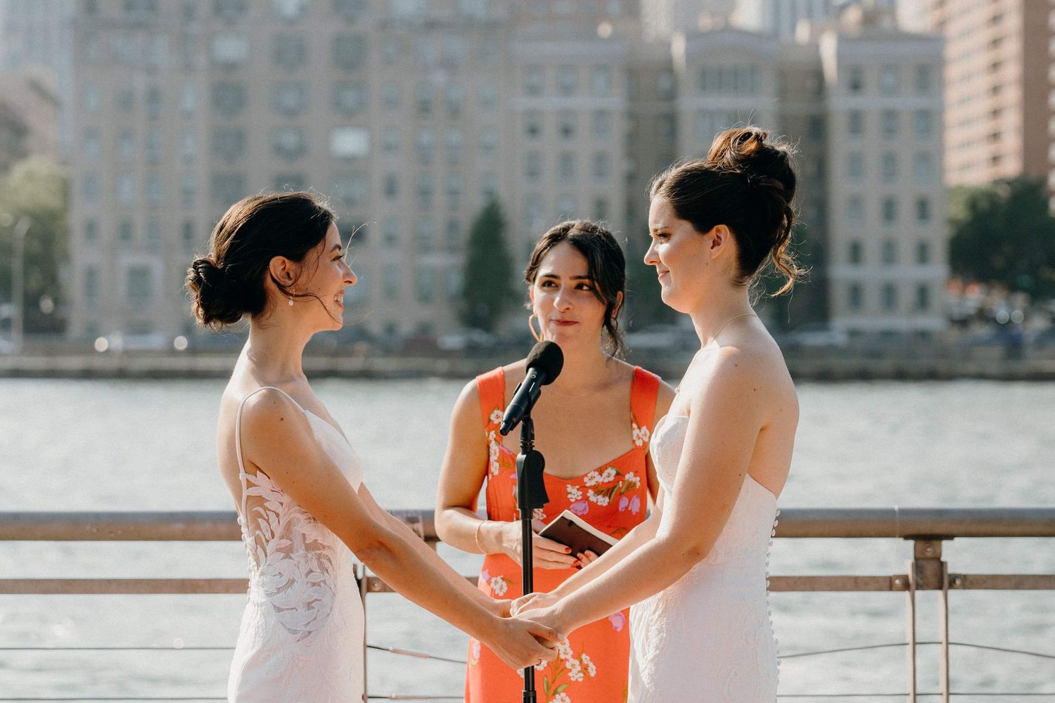 A wedding ceremony takes place on a waterfront pier at the Sanctuary Roosevelt Island NYC
