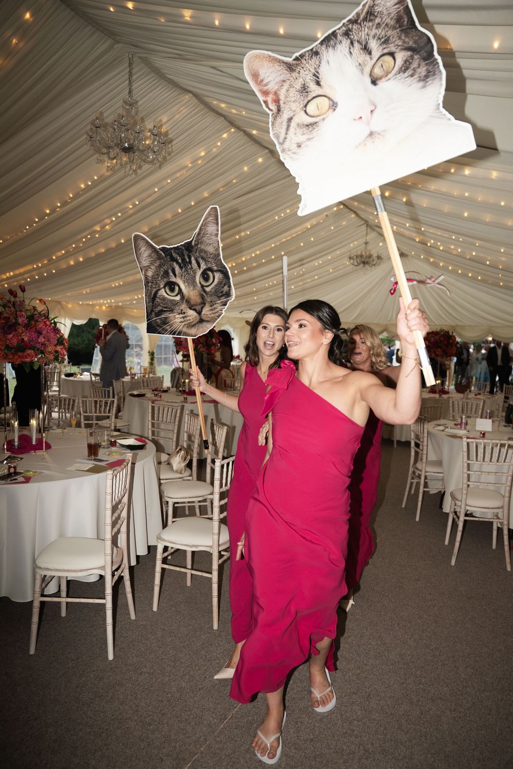 A series of photos showing dancers in red dresses twirling under decorative lights in a white tent reception venue.