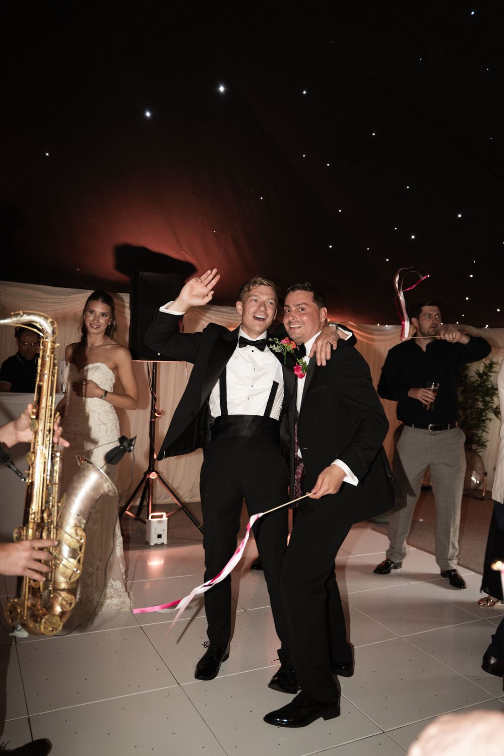 A sequence of festive party guests dancing energetically in formal attire at a nighttime reception event.