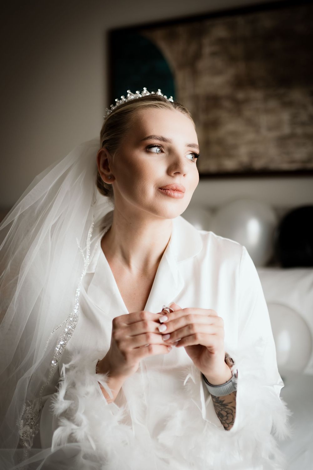 A sequence of bridal portraits showing a person in white adjusting their clothing while wearing a delicate tiara and veil.
