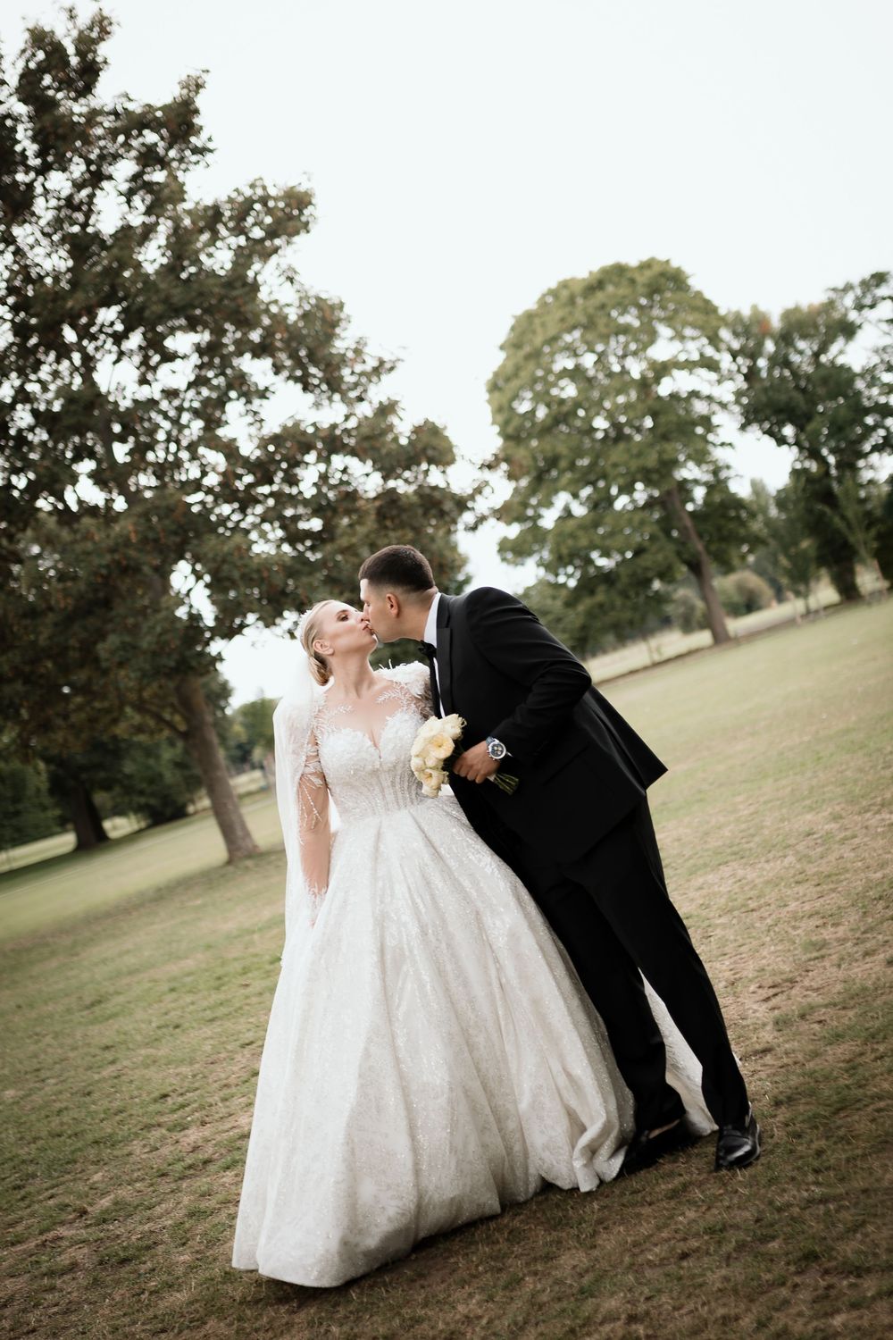 A romantic hillside wedding photo series shows the couple in elegant white dress and black tuxedo sharing intimate moments.