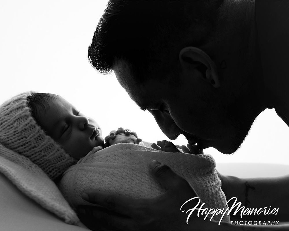 Black and white silhouette of intimate newborn photography session.