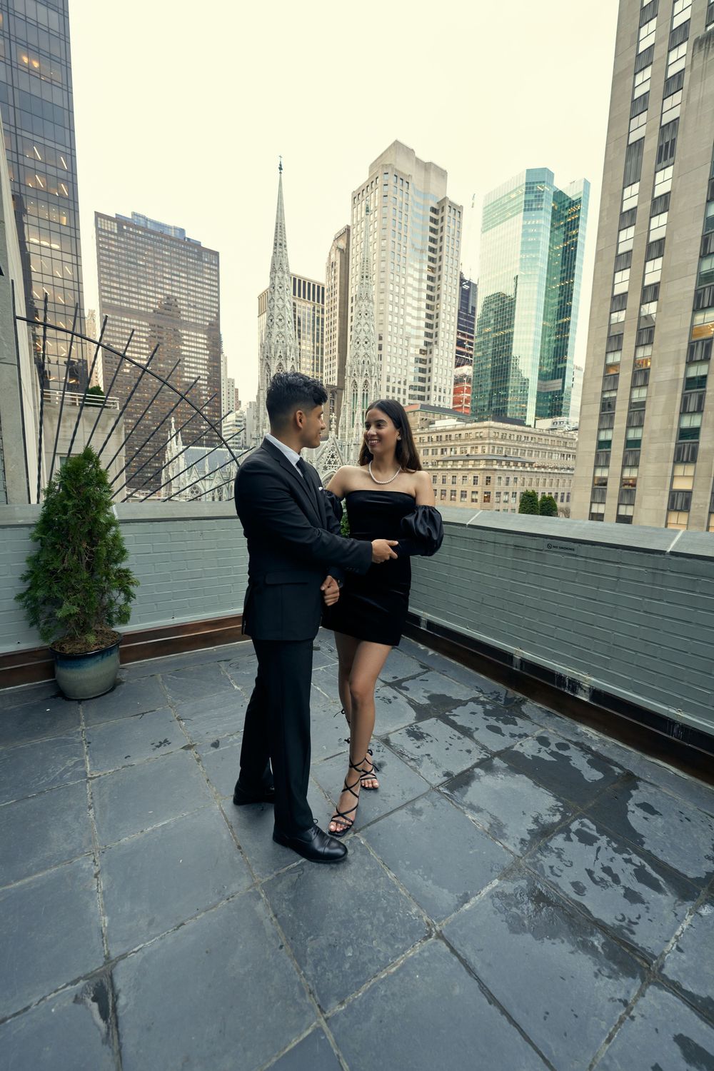 A couple shares a romantic dance sequence on a city rooftop terrace with skyscrapers in the background by 3 West Club manhattan