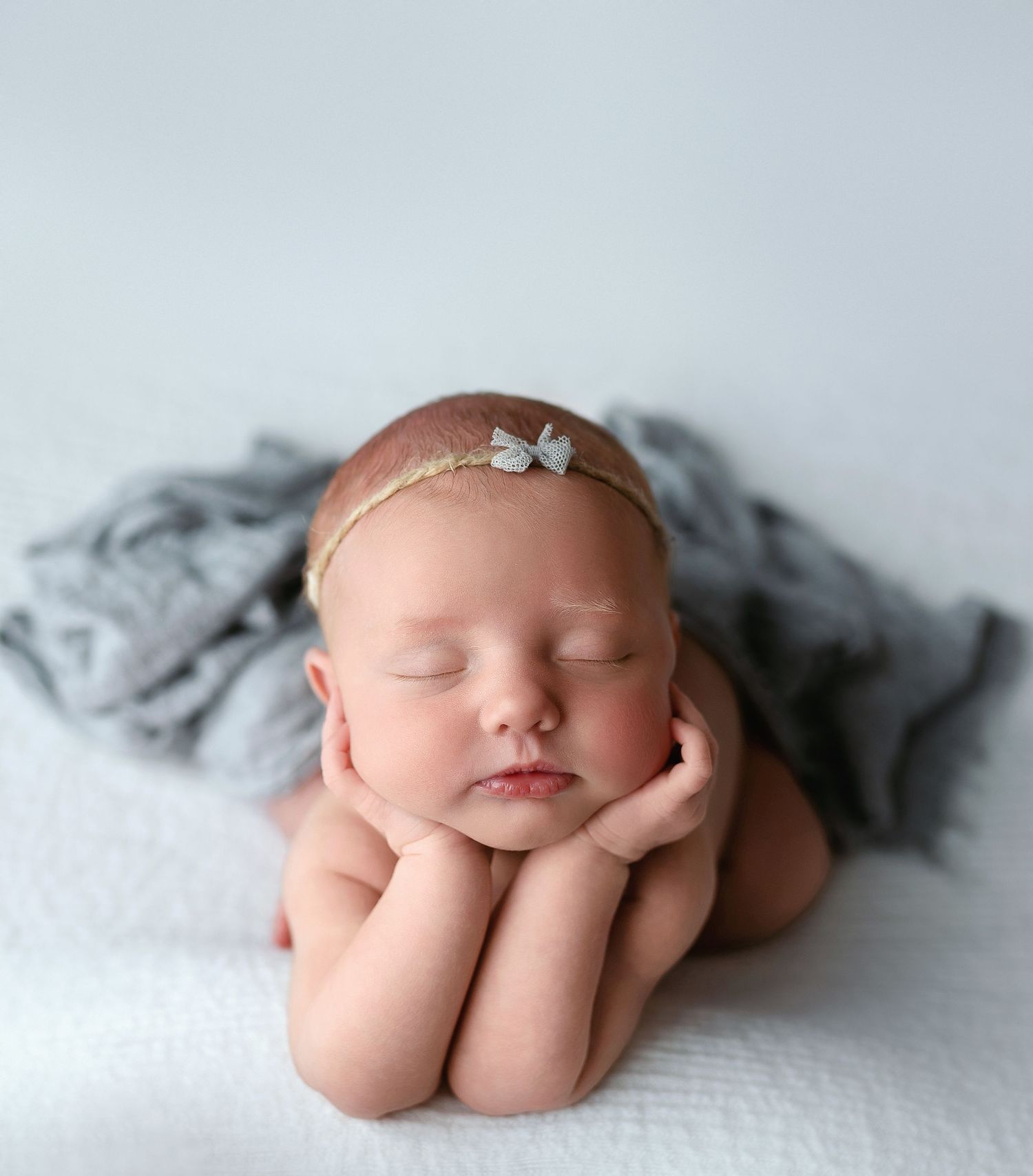 A newborn girl doing the froggie pose with a gray wrap. - Greenville SC newborn photographer - Easley SC newborn photographer