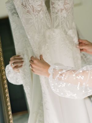 Close-up details of a white lace wedding dress with intricate patterns shown in multiple angles.