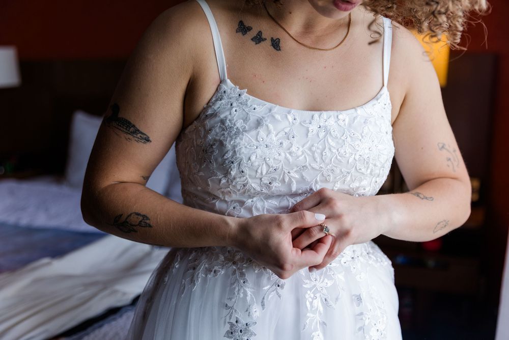 A close-up view of a white lace wedding dress bodice details with a sweetheart neckline.