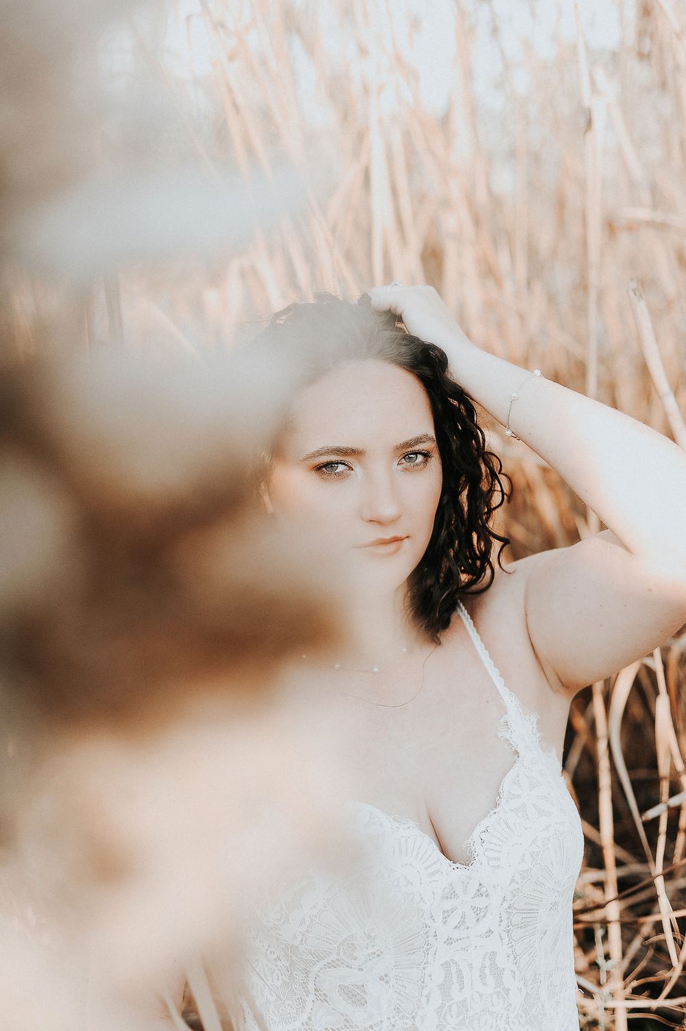 Dreamy bridal portrait in soft focus with delicate lace details and ethereal lighting.