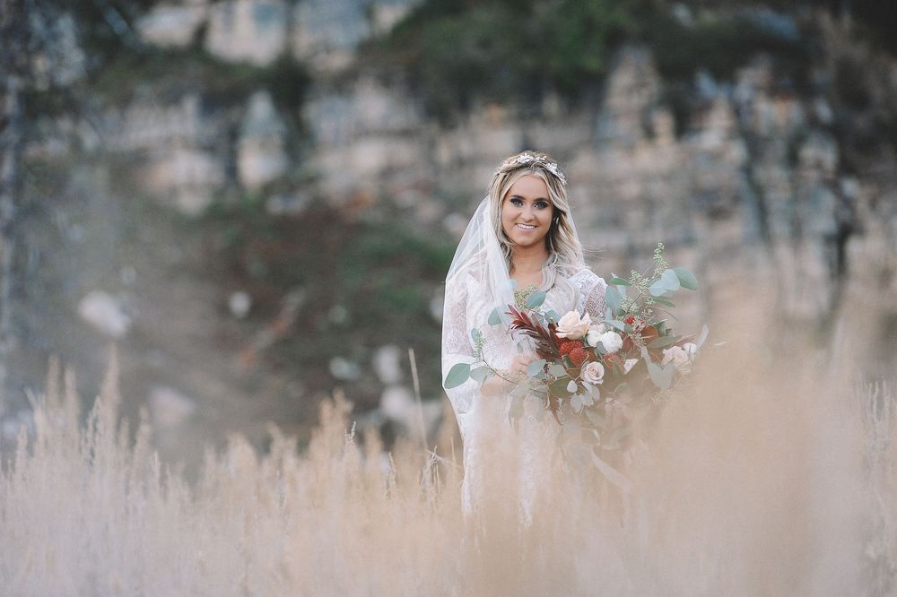 Dreamy bridal portrait with soft focus and natural mountain backdrop.