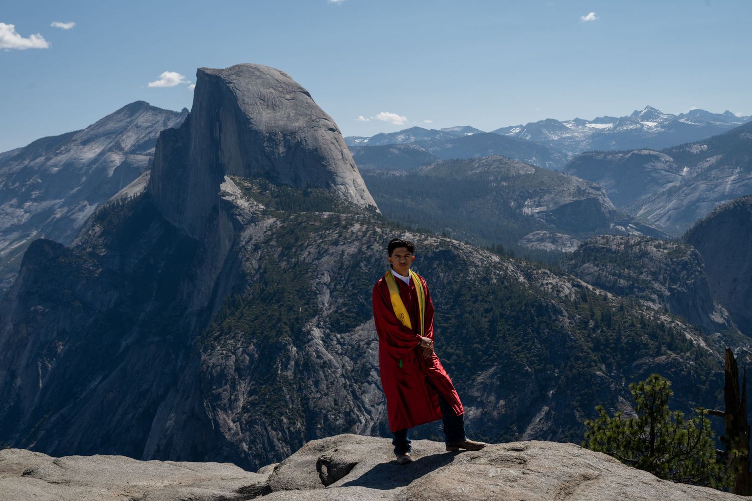 Panoramic vista of Half Dome and Yosemite Valley's dramatic mountain landscape from Glacier Point overlook.