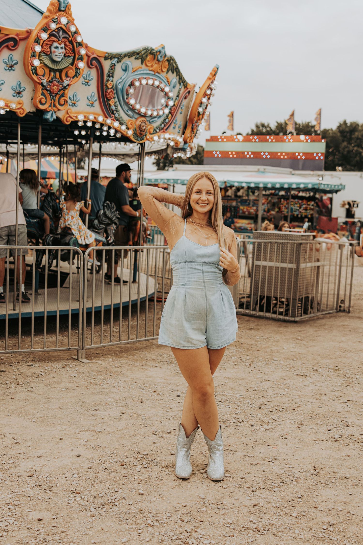 A series of shots in summery outfits at a carnival fairground with vintage rides and attractions in the background.